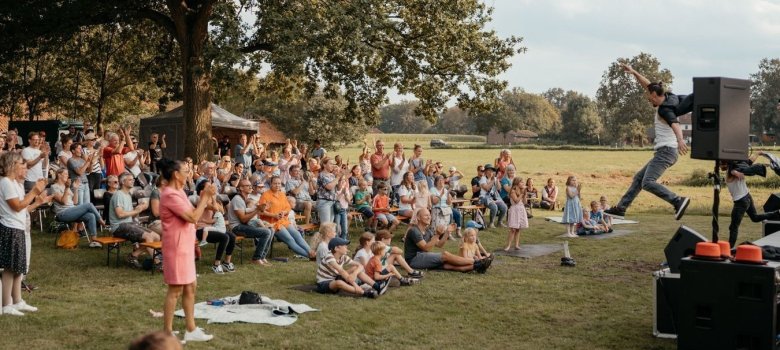Bühne mit Artisten, davor Publikum
